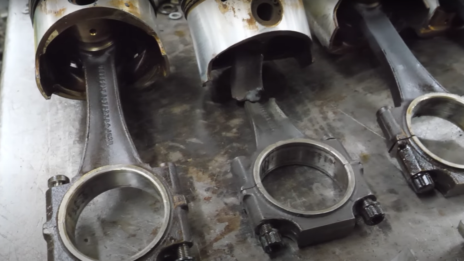 The pistons from a hydrolocked Bentley V8, including one with a snapped conrod